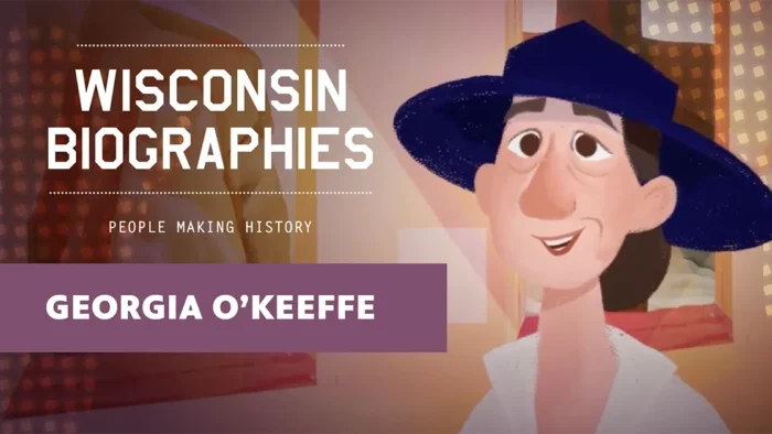 Cartoon-style portrait of Georgia O’Keeffe wearing a wide-brimmed blue hat and smiling in front of framed artwork.