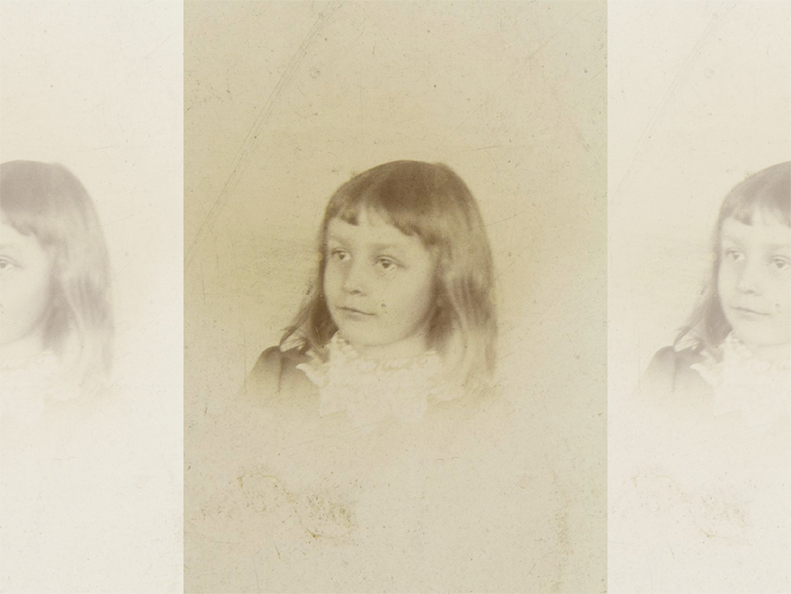 A black and white photograph of a young girl with long hair.