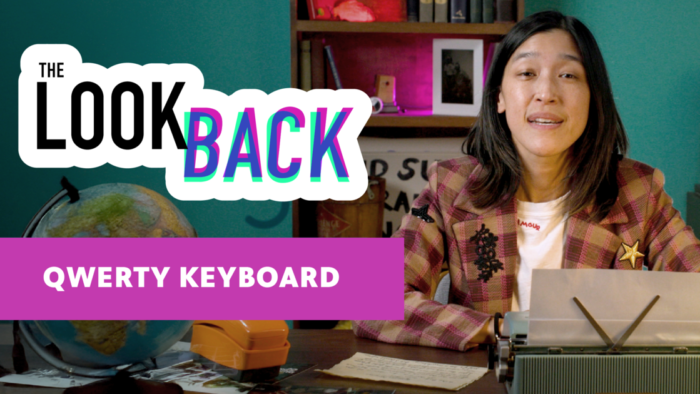 Person in plaid blazer sits at a desk with a typewriter under the title “The Look Back.” Bold text below reads “QWERTY Keyboard.”