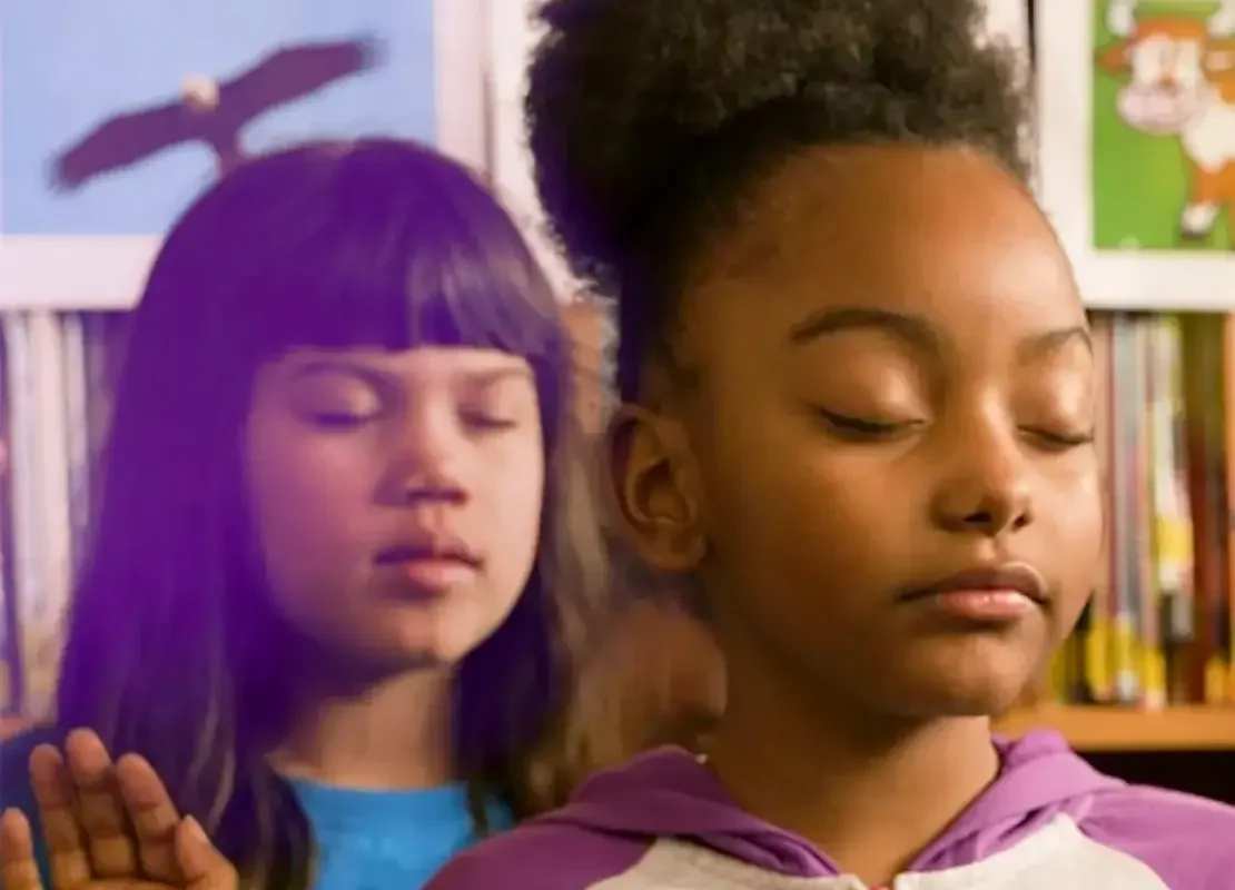 Two children practicing mindfulness with their eyes closed