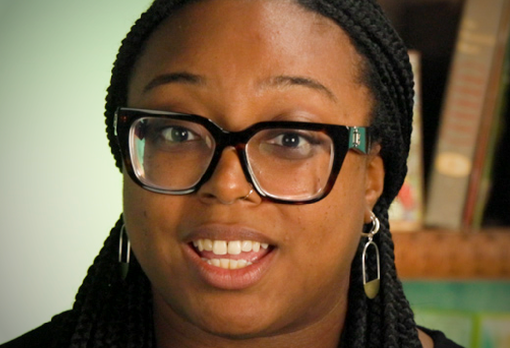 Person with long braids and dark-rimmed glasses.
