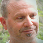 Person with close-cropped hair and a small goatee.