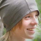 Smiling person in a gray knit cap.